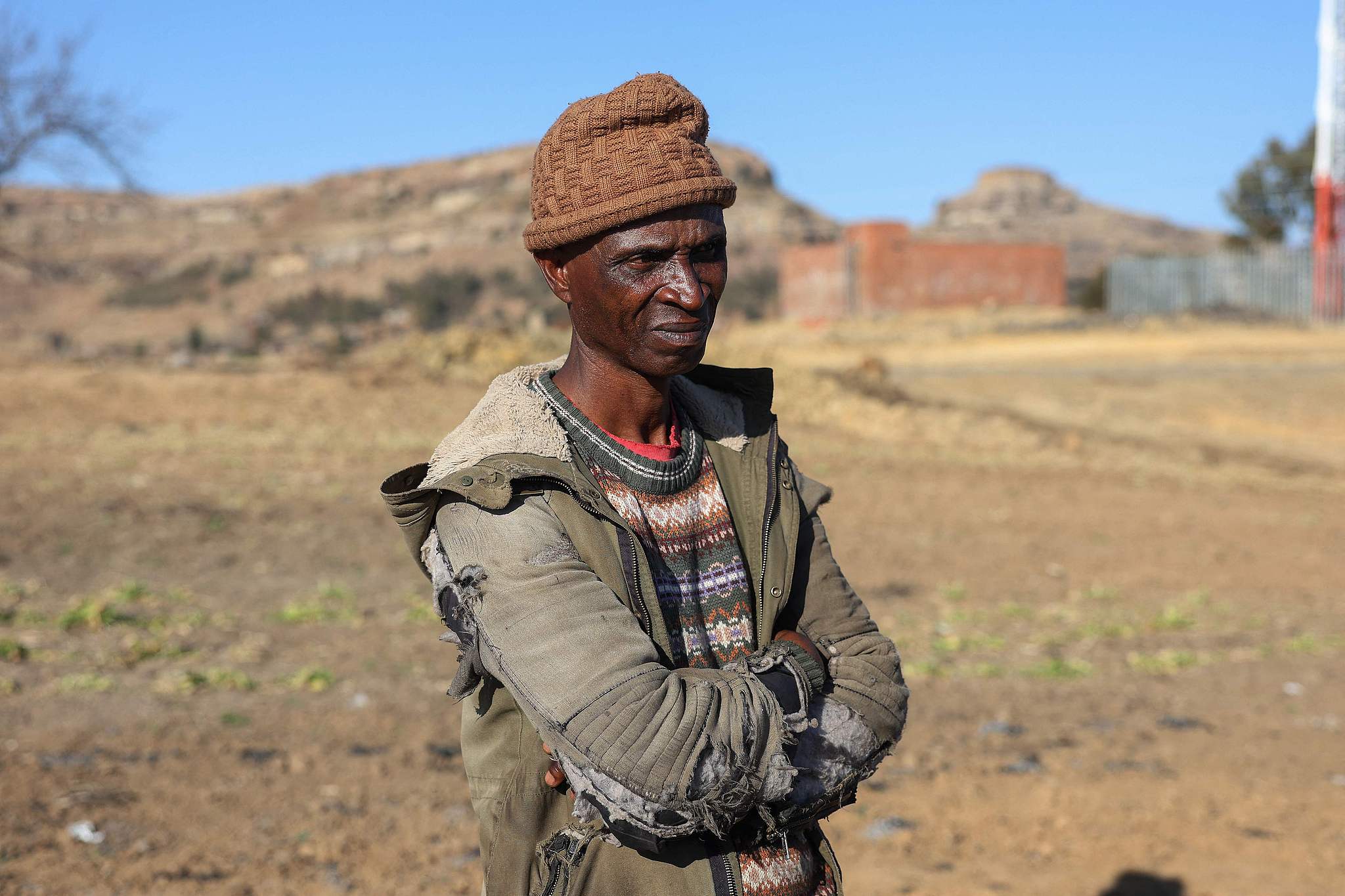 FILE: Daniel Phoofolo (55), a subsistence farmer, looks on near his vegetable garden with dried-up crops in Butha-Buthe District, Lesotho, on August 7, 2024. /VCG