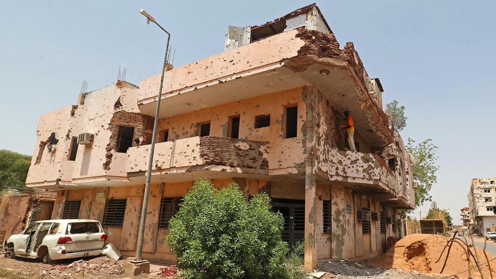 A worker repairs a damaged building in Khartoum following the return of displaced Sudanese to the capital on September 20, 2026. /VCG