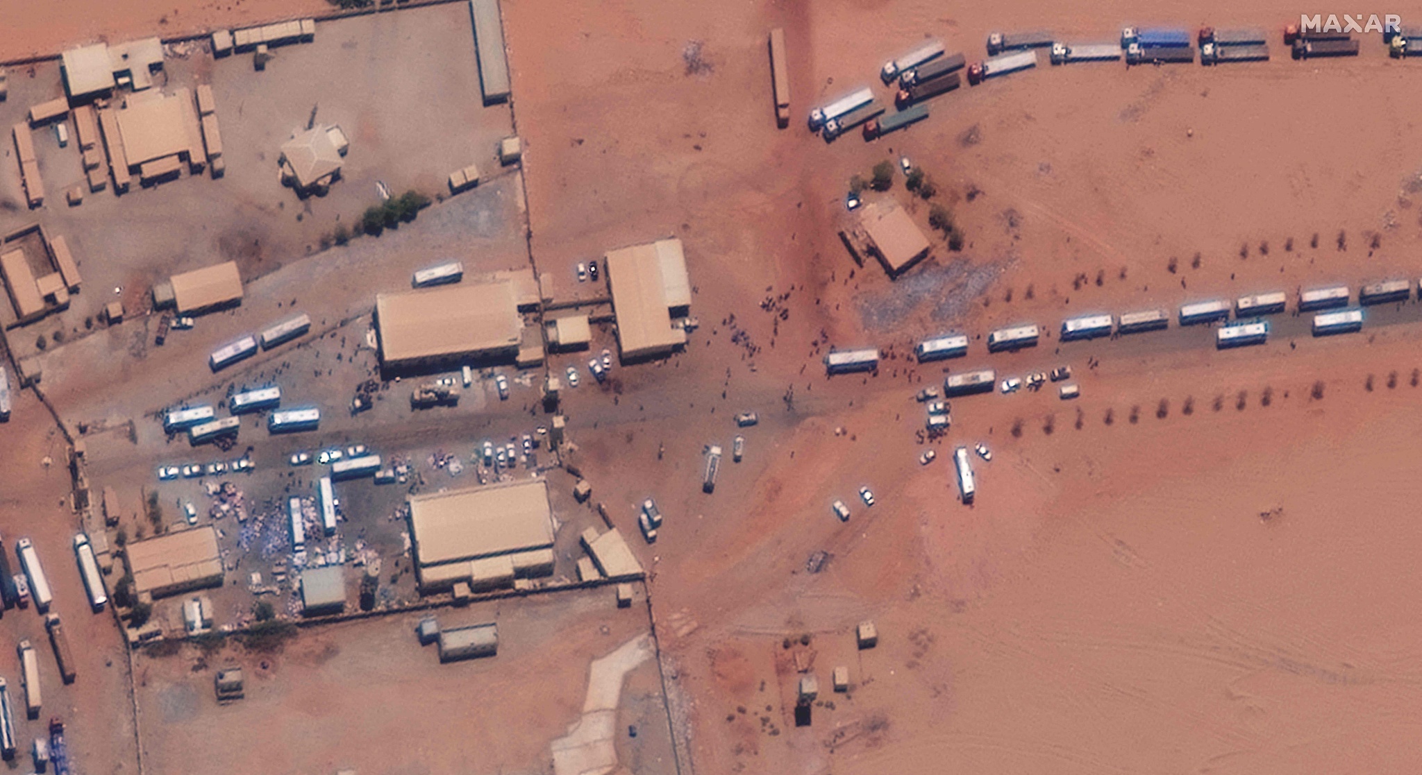 A satellite photograph shows a major crossing point near the Sudanese eastern border post of the A1 highway with Egypt, as buses wait in line to evacuate passengers into Egypt, April 28, 2023. /VCG