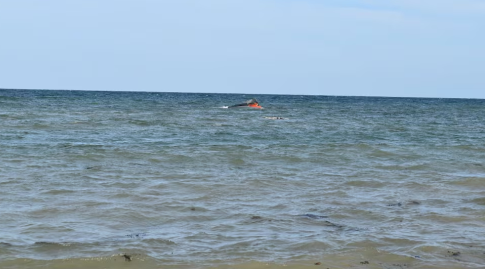 A portion of the vessel floats after it capsized while carrying 305 people from Djibouti to Yemen, leaving at least 139 dead, October 10, 2026. /Reuters