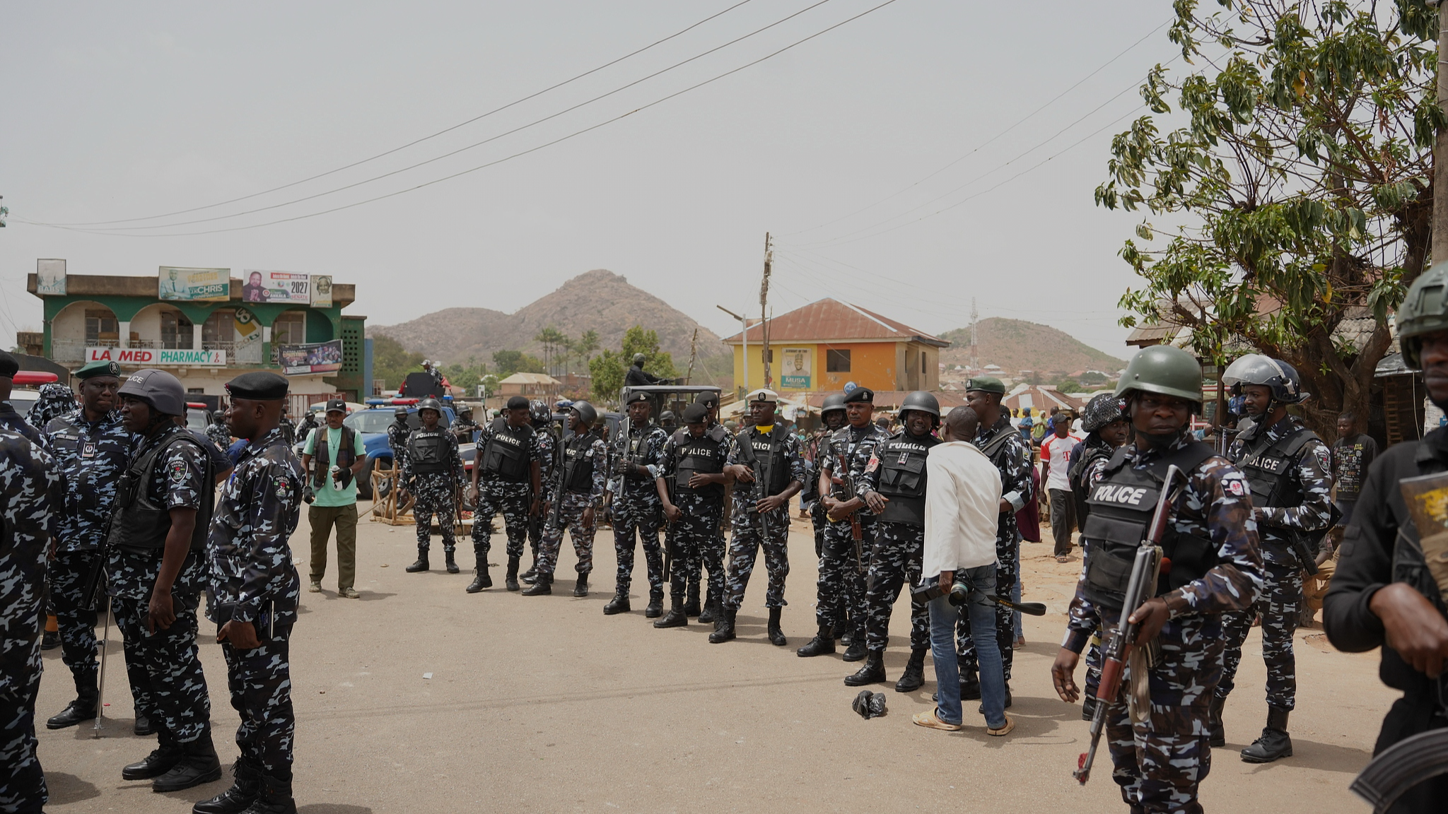FILE: Police officers gather at the scene of an armed attack in Gari Ya Waye community in Jos North, Nigeria, March 30, 2026. /VCG
